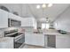 Bright kitchen features white cabinets, a stainless steel oven, and marble countertops, creating an ideal space for culinary endeavors at 1486 Loman Ct, Palm Harbor, FL 34683