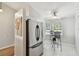 Eat-in kitchen with stainless steel fridge and light-filled dinette area at 1486 Loman Ct, Palm Harbor, FL 34683