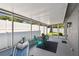 View of a screened lanai furnished with chairs and a hammock, providing a relaxing outdoor retreat at 1486 Loman Ct, Palm Harbor, FL 34683