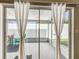 View of a screened lanai showcasing a seating area and access to the backyard through sliding glass doors at 1486 Loman Ct, Palm Harbor, FL 34683
