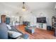 Cozy living room with wood floors and open concept dining, great for relaxation and entertaining at 1486 Loman Ct, Palm Harbor, FL 34683