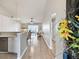 Bright living room with wood floors, chandelier and view from the kitchen at 1486 Loman Ct, Palm Harbor, FL 34683