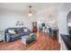 Inviting living room featuring hard wood floors, neutral paint, and an open floor plan to adjoining kitchen at 1486 Loman Ct, Palm Harbor, FL 34683
