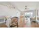 Bright living room with vaulted ceiling, chandelier, wood floors, and access to outdoor patio at 1486 Loman Ct, Palm Harbor, FL 34683
