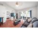 A cozy living room with wood floors and lots of natural light. Sliding glass doors lead to the outside patio at 1486 Loman Ct, Palm Harbor, FL 34683