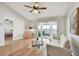 Bright living room with wood flooring, patio access, ceiling fan, and view into bedroom at 1486 Loman Ct, Palm Harbor, FL 34683