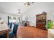 Open concept living room and dining room with wood floors and lots of natural light from sliding glass doors at 1486 Loman Ct, Palm Harbor, FL 34683