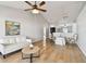 Bright living area with wood flooring, soft white sofa, and dining area beyond half wall at 1486 Loman Ct, Palm Harbor, FL 34683