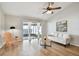 Bright living room featuring a modern sofa, wood flooring, and patio access at 1486 Loman Ct, Palm Harbor, FL 34683