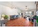 Open concept living room and dining room with wood floors and plenty of natural light from sliding glass doors at 1486 Loman Ct, Palm Harbor, FL 34683