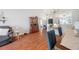 Open living space features wood floors, modern design, and smooth transition to the kitchen, enhancing comfort and style at 1486 Loman Ct, Palm Harbor, FL 34683
