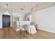 Inviting living space with dining area, black entry door, and light hardwood floors at 1486 Loman Ct, Palm Harbor, FL 34683