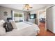 Relax in this spacious main bedroom featuring an ensuite bathroom and nearby living area at 1486 Loman Ct, Palm Harbor, FL 34683