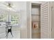 Pantry with open white louvered doors and wire shelving, located adjacent to the breakfast nook at 1486 Loman Ct, Palm Harbor, FL 34683