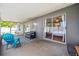 View of the covered patio that includes comfortable seating, rug, and access to the lush outdoor space at 1486 Loman Ct, Palm Harbor, FL 34683