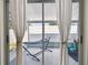 Enclosed patio with white curtains, a hammock, and chair; ideal for relaxation and enjoying the outdoors at 1486 Loman Ct, Palm Harbor, FL 34683