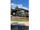 City of Dunedin public space with a central gazebo and brick-lined stage surrounded by colorful flowerbeds at 1486 Loman Ct, Palm Harbor, FL 34683