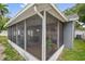 Relaxing screened-in porch provides an airy space for outdoor enjoyment and entertainment at 1486 Loman Ct, Palm Harbor, FL 34683