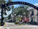 Charming downtown streetscape featuring the 'Shops on Broadway' sign and archway honoring the U.S. Military at 1486 Loman Ct, Palm Harbor, FL 34683