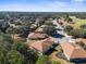 Aerial view showcasing residential neighborhood, golf course, and mature landscaping in a serene community setting at 15038 Sterling Run, Brooksville, FL 34609