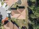 Aerial view of a single-Gathering home featuring a brown shingle roof, mature landscaping, and a well-maintained lawn at 15038 Sterling Run, Brooksville, FL 34609