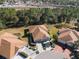 Aerial view of the house featuring a brick driveway, a two-car garage, and mature landscaping for curb appeal at 15038 Sterling Run, Brooksville, FL 34609