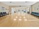 Empty ballroom with hardwood floors, ceiling fans, and a row of chairs along the wall at 15038 Sterling Run, Brooksville, FL 34609