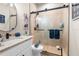 This bathroom features updated granite countertops, sleek faucets, and a glass enclosed shower at 15038 Sterling Run, Brooksville, FL 34609