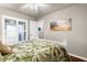 This bright bedroom features a ceiling fan, luxury vinyl floors, and a large window at 15038 Sterling Run, Brooksville, FL 34609