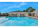 Sparkling community pool with inviting blue water and chairs in background at 15038 Sterling Run, Brooksville, FL 34609