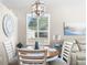 Cozy dining area with a round table, white chairs, shuttered windows and beach themed decor at 15038 Sterling Run, Brooksville, FL 34609
