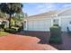 Spacious two-car garage with a beautifully paved driveway and well-manicured landscaping at 15038 Sterling Run, Brooksville, FL 34609