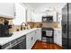 Modern kitchen featuring white cabinets, stainless steel appliances, and stylish backsplash at 15038 Sterling Run, Brooksville, FL 34609