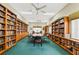 A book-lined community library offers a vast collection of books, reading chairs, and a large conference table at 15038 Sterling Run, Brooksville, FL 34609