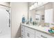 This bathroom features updated granite countertops, sleek faucets and a walk-in shower at 15038 Sterling Run, Brooksville, FL 34609
