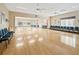 Spacious meeting room with bright hardwood floors and large opening to an additional area at 15038 Sterling Run, Brooksville, FL 34609