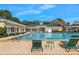 A pristine pool and pool deck with green lounge chairs offer residents a refreshing and relaxing community amenity at 15038 Sterling Run, Brooksville, FL 34609