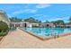 An inviting swimming pool is surrounded by a brick-paved deck and beautiful clubhouse perfect for all at 15038 Sterling Run, Brooksville, FL 34609