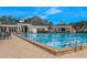 A sparkling blue swimming pool with lane markers and a brick-paved deck is ready for a new resident at 15038 Sterling Run, Brooksville, FL 34609
