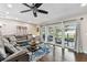 Cozy living room featuring a comfortable sectional sofa, stylish rug, and sliding doors to the outdoor patio at 1509 Poinsettia Ave, Tarpon Springs, FL 34689