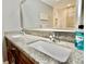 Close-up of bathroom vanity with granite countertop, double sinks, and chrome faucets at 1723 Cortleigh Dr, Trinity, FL 34655