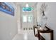 Welcoming foyer with tile flooring, a decorative glass transom, console table, and a painting, creating a stylish entrance at 1723 Cortleigh Dr, Trinity, FL 34655