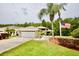 Charming home with a well-manicured lawn, palm trees, and an American flag, creating a welcoming curb appeal at 1723 Cortleigh Dr, Trinity, FL 34655