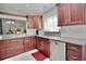 Updated kitchen with granite counters, tile backsplash, stainless appliances, and generous cabinet space at 1723 Cortleigh Dr, Trinity, FL 34655