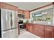 Spacious kitchen featuring stainless steel appliances, granite countertops, and wood cabinetry at 1723 Cortleigh Dr, Trinity, FL 34655