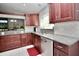 Updated kitchen with granite counters, tile backsplash, stainless appliances, and generous cabinet space at 1723 Cortleigh Dr, Trinity, FL 34655