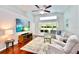 Open concept living room with vaulted ceiling, hardwood floors, and a large sectional sofa at 1723 Cortleigh Dr, Trinity, FL 34655
