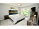 Spacious main bedroom with rustic wood accents, large window, and vaulted ceilings at 1723 Cortleigh Dr, Trinity, FL 34655