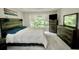 Spacious main bedroom with rustic wood accents, large window, and vaulted ceilings at 1723 Cortleigh Dr, Trinity, FL 34655
