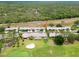 Beautiful aerial view of residences near a golf course, showcasing a well-kept community amidst green spaces at 18418 Bent Pine Dr, Hudson, FL 34667